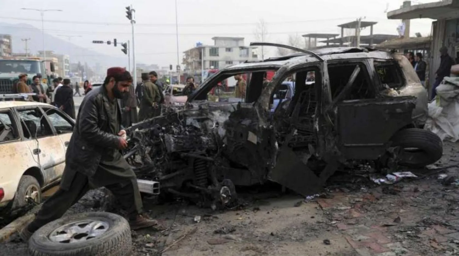 FILE PHOTO: People gather near the site of a deadly bombing attack in Kabul, Afghanistan, Sunday, Dec. 20, 2020.  (AP Photo/Rahmat Gul)
