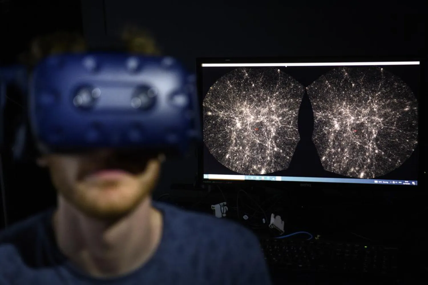 FILE - In this Oct. 12, 2021 file photo, Hadrien Gurnel, software engineer EPFL's Laboratory for Experimental Museology (eM+) explores with a virtual reality helmet the most detailed 3D map of the universe with the virtual reality software VIRUP. (Laurent Gillieron/Keystone via AP)
