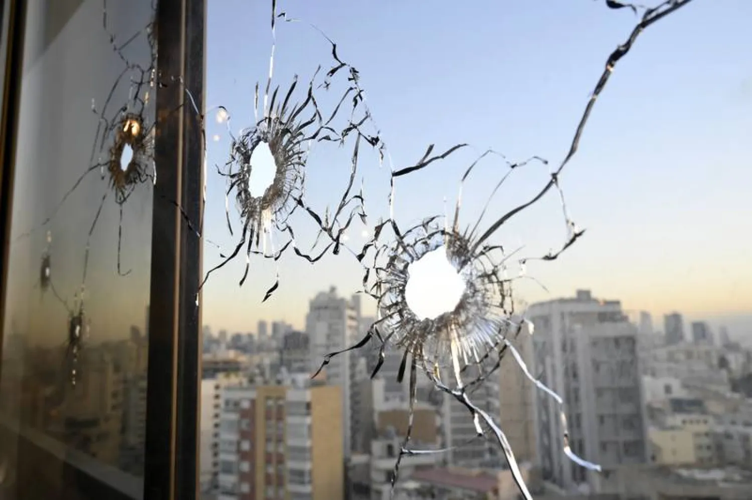 Bullet holes on a window of an apartment building following the Beirut clashes. (EPA)