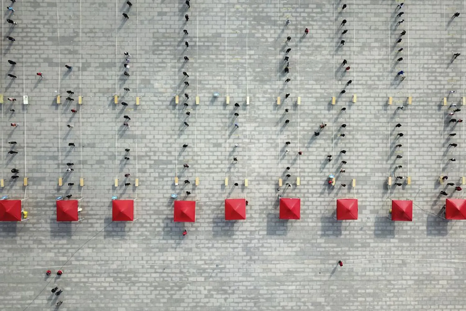 This photo released by Xinhua News Agency shows an aerial view of residents lining up to receive a swab for the coronavirus test during a mass testing in Lanzhou, capital city of northwest China's Gansu Province, Sunday, Oct. 24, 2021. (AP)