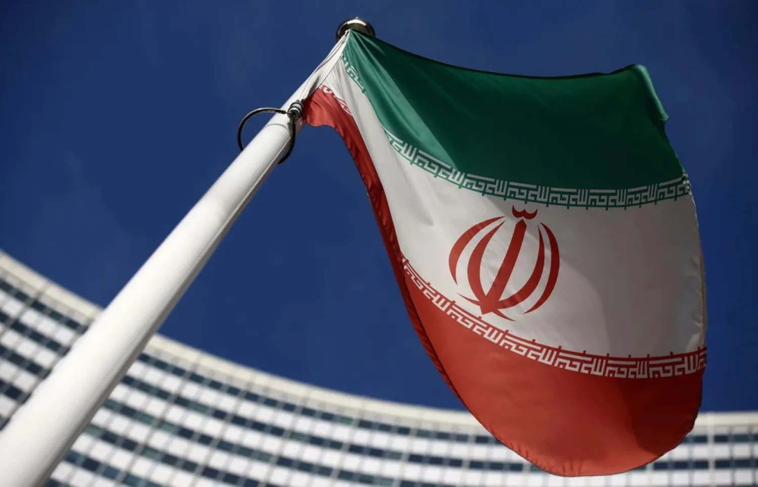 The Iranian flag waves in front of the International Atomic Energy Agency (IAEA) headquarters, before the beginning of a board of governors meeting, amid the coronavirus disease (COVID-19) outbreak in Vienna, Austria, March 1, 2021. (Reuters)