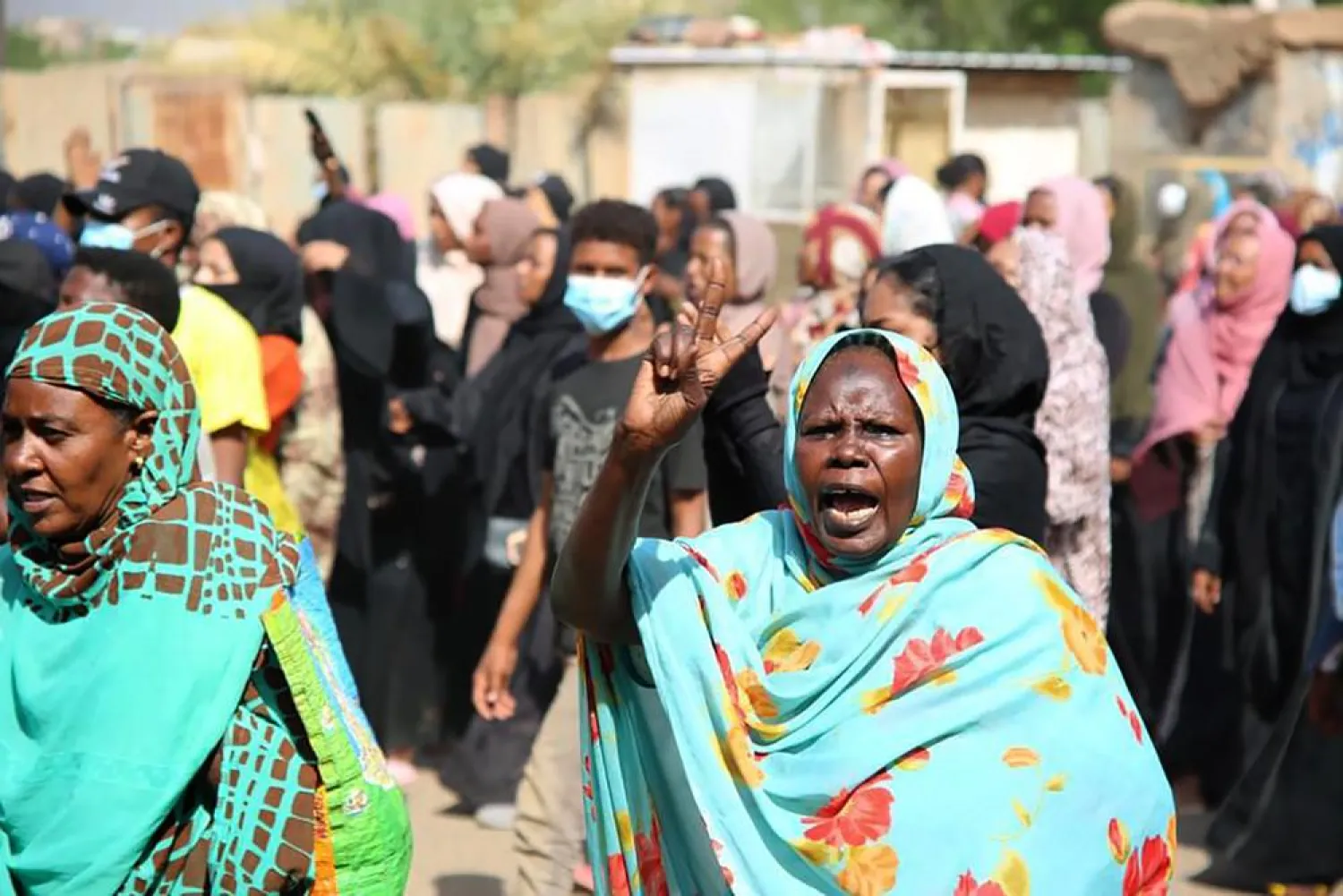 A pro-democracy protester flashes the victory sign as thousands take to the streets to condemn a takeover by military officials, in Khartoum, Sudan, Monday Oct. 25, 2021. (AP)