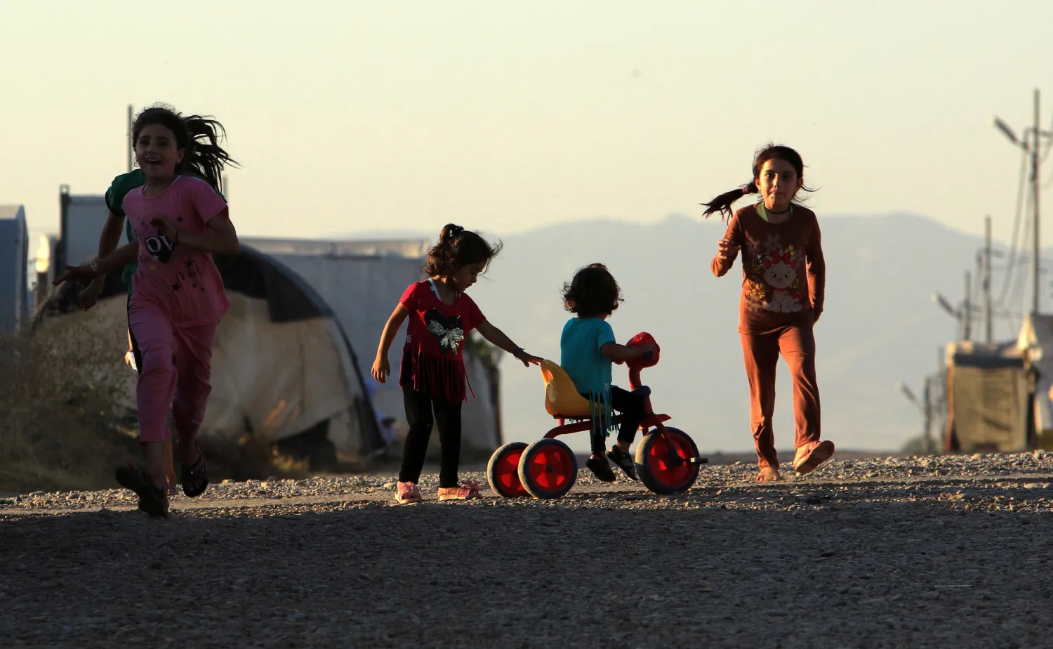 Displaced Iraqi children from the minority Yazidi sect, who fled the Iraqi town of Sinjar, play at the Khanki camp on the outskirts of Dohuk province, July 31, 2019. Reuters