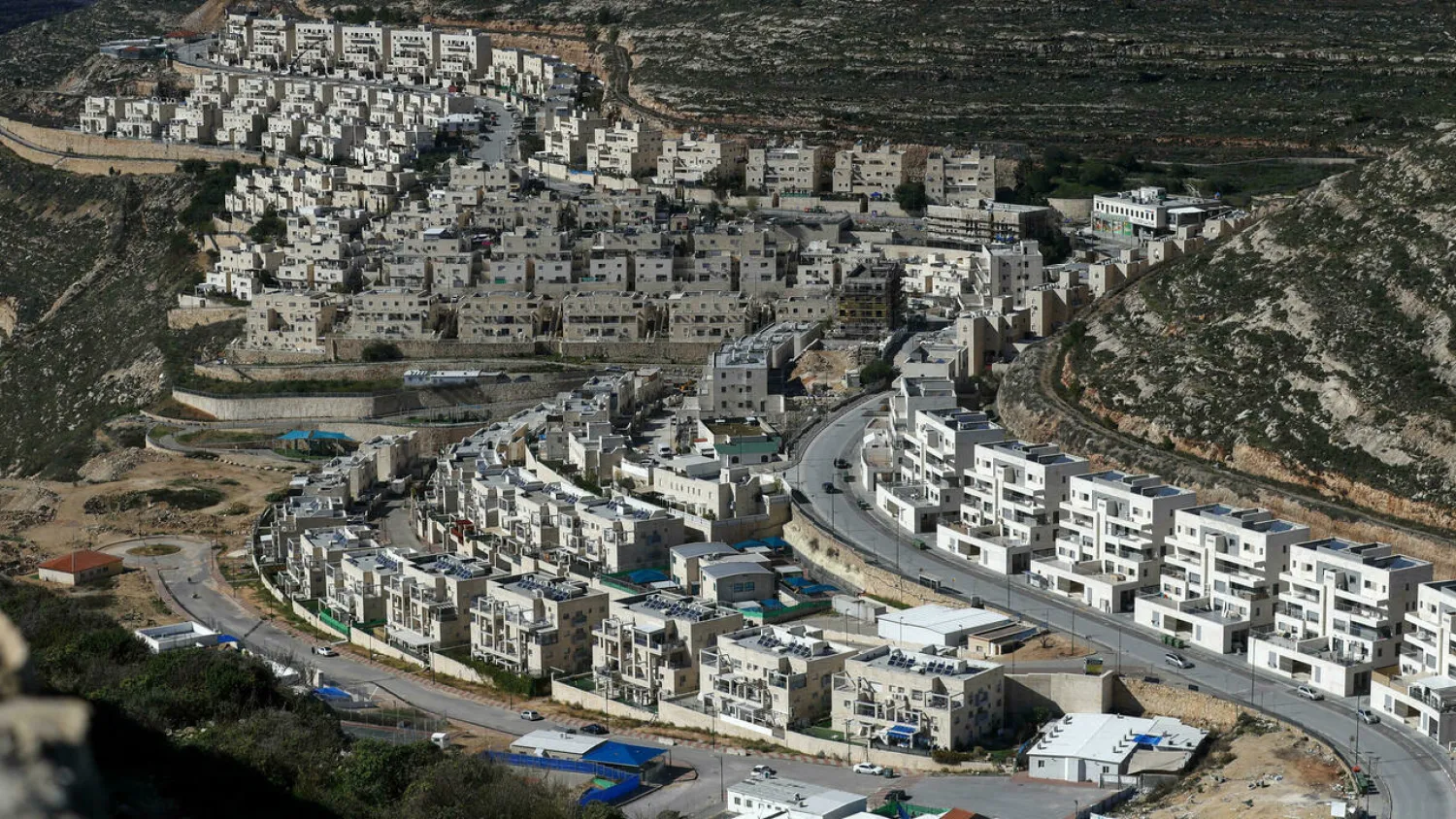 Construction work is pictured on January 21, 2021 in the Israeli settlement of Givat Zeev, near the Palestinian city of Ramallah in the occupied West Bank. (AFP)