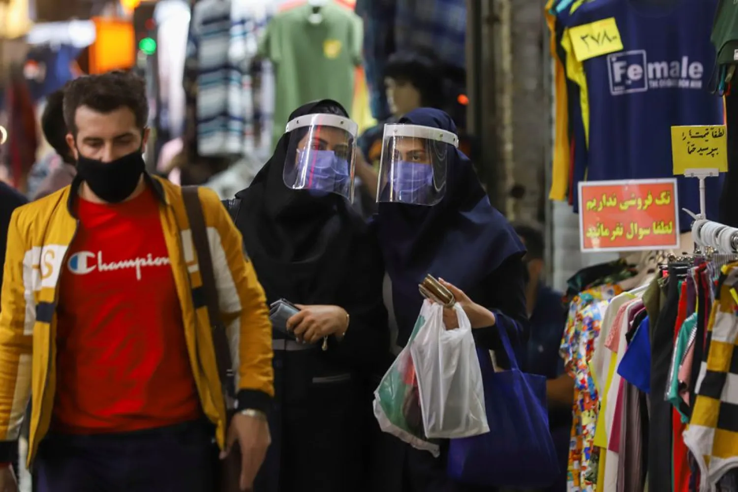 Iranian women wear protective face shields and masks as they walk in Tehran Bazaar in Tehran, Iran April 6, 2021. Majid Asgaripour/WANA (West Asia News Agency) via REUTERS