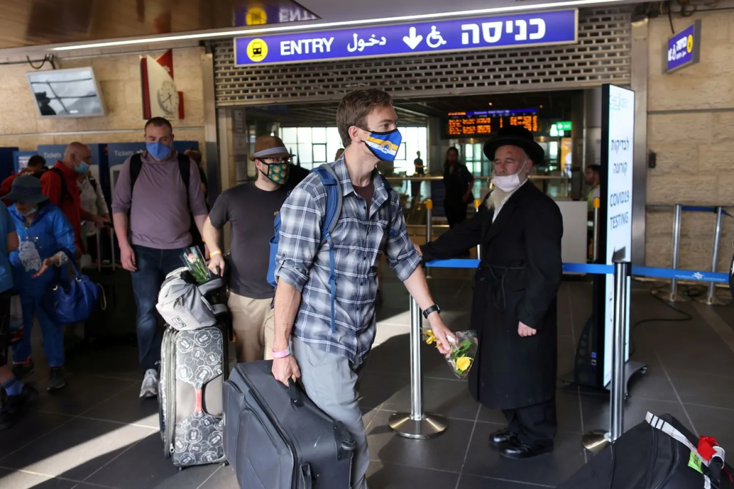 Tourists walk at the Ben Gurion International Airport after entering Israel by plane, as coronavirus disease (COVID-19) restrictions ease, in Lod, near Tel Aviv, Israel, May 27, 2021. Reuters