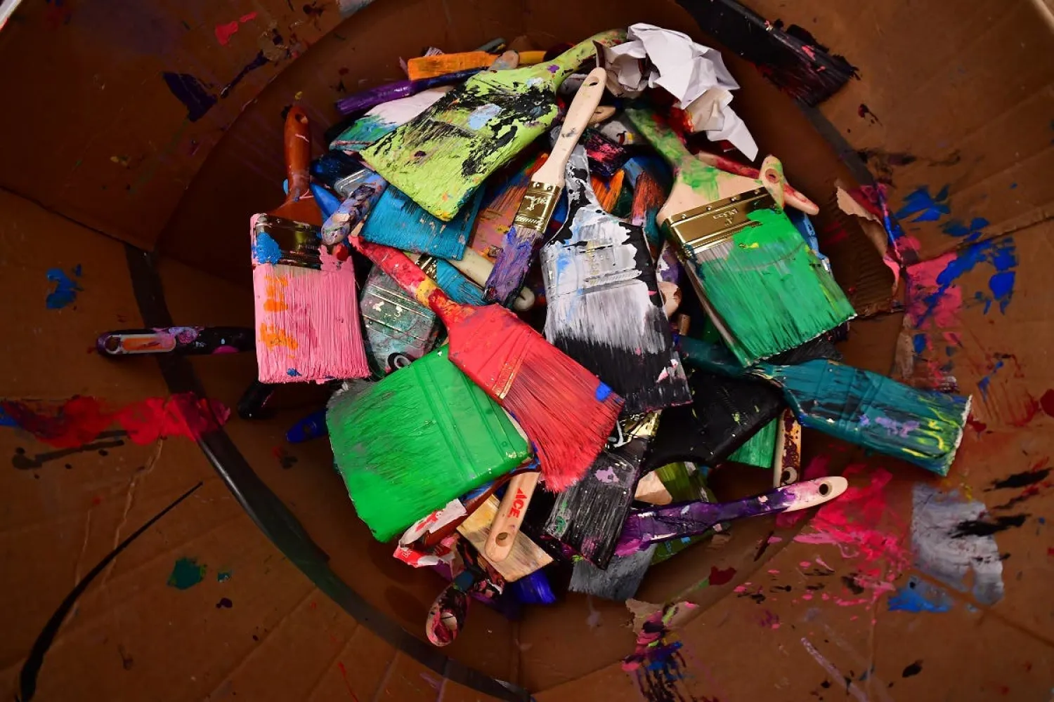 A picture taken on September 23, 2020, shows some of the
brushes of contemporary British artist Sacha Jafri sitting with which
he worked on his record-breaking painting entitled 'The Journey of
Humanity', in the Emirati city of Dubai. (AFP)