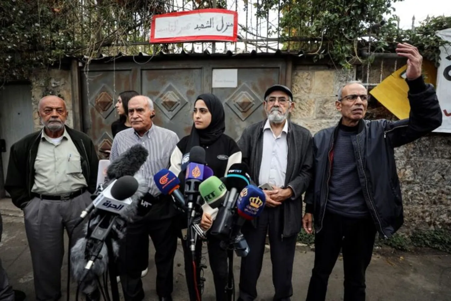 Palestinian activist Muna El-Kurd stands with her family members at a media conference in the East Jerusalem neighborhood of Sheikh Jarrah November 2, 2021. (Reuters)