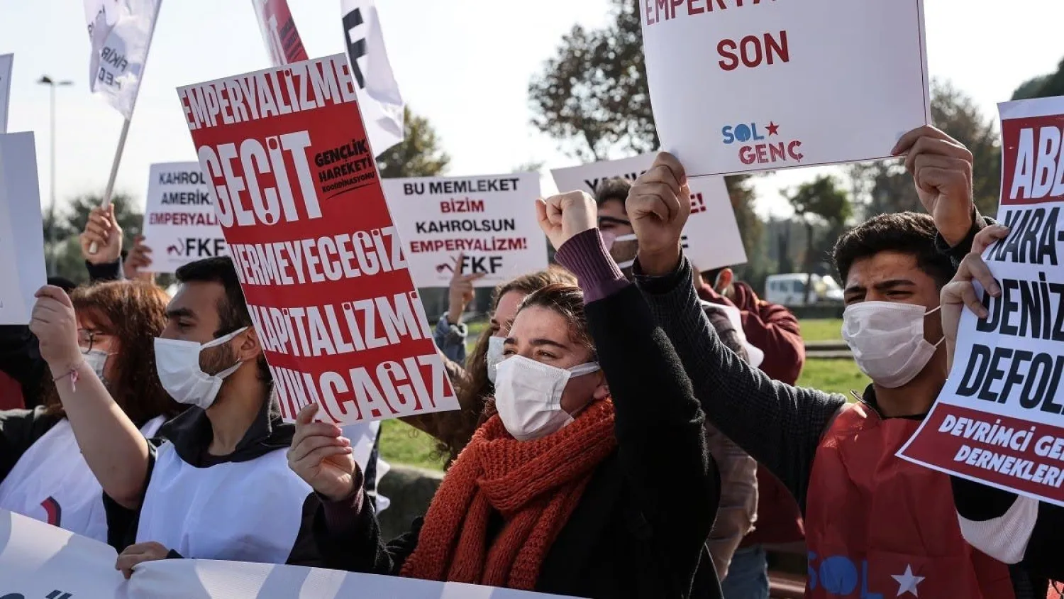 People shout slogans as they protest where the USS Mount Whitney (LCC-20), flagship of the US Navy’s Sixth Fleet, is docked in Istanbul, Nov. 3, 2021. (Reuters)