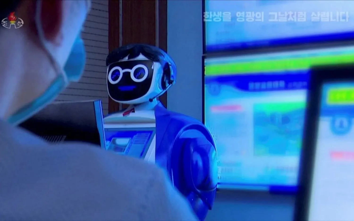 A North Korean student sits in front of a robot in Pyongyang, North Korea November 3, 2021, in this still image obtained from Reuters TV. (KRT via Reuters)
