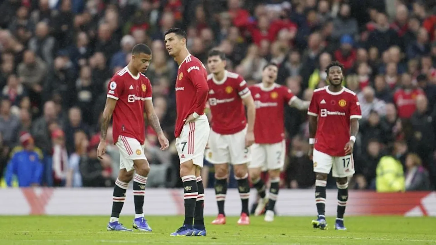 Manchester United players react during the match against City. (AP)