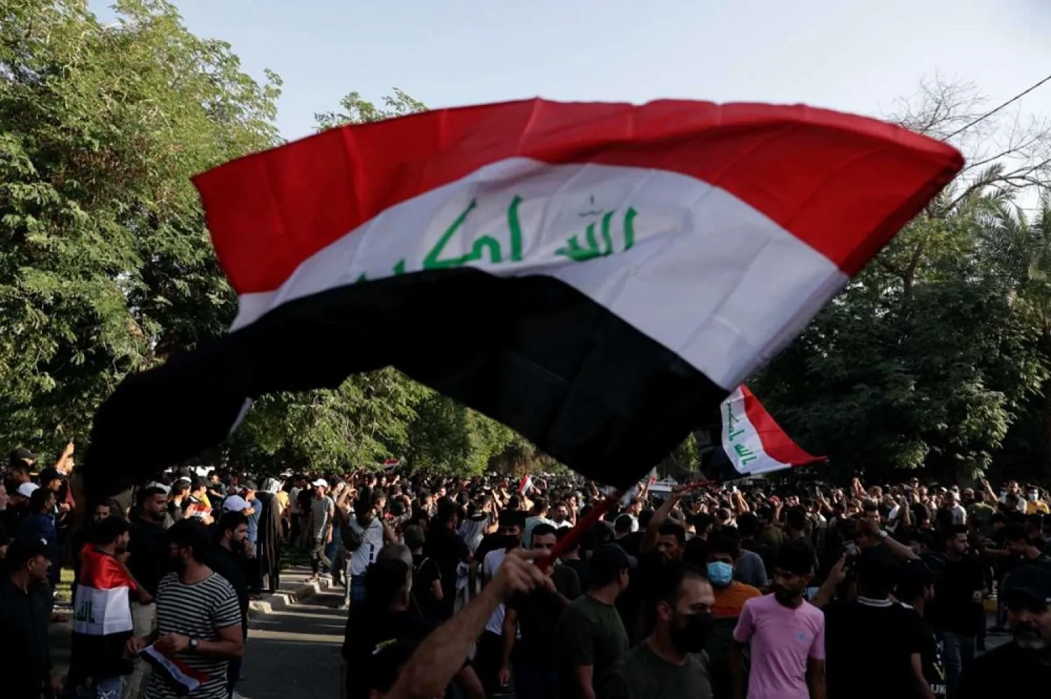 Protesters denounce election results and call for a manual recount of the Oct. 10 parliamentary vote outside the heavily fortified Green Zone in Baghdad, Iraq, Sunday, Oct. 31, 2021. (AP)