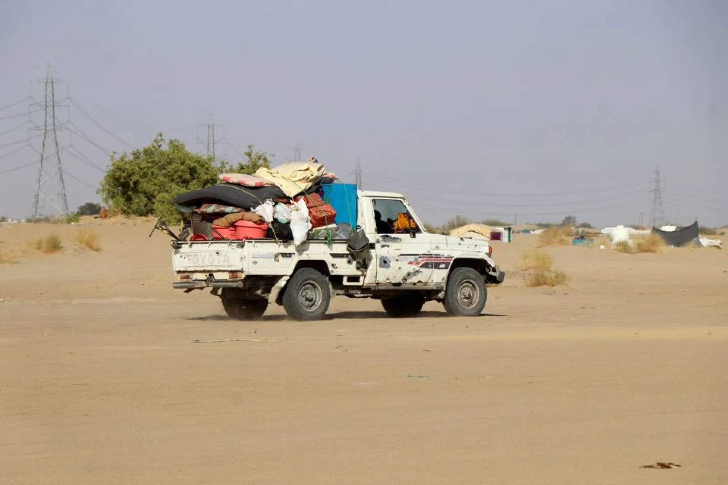 A truck loaded with furniture is pictured near a camp for internally displaced people (IDPs) in Marib, Yemen November 2, 2021. (Reuters)