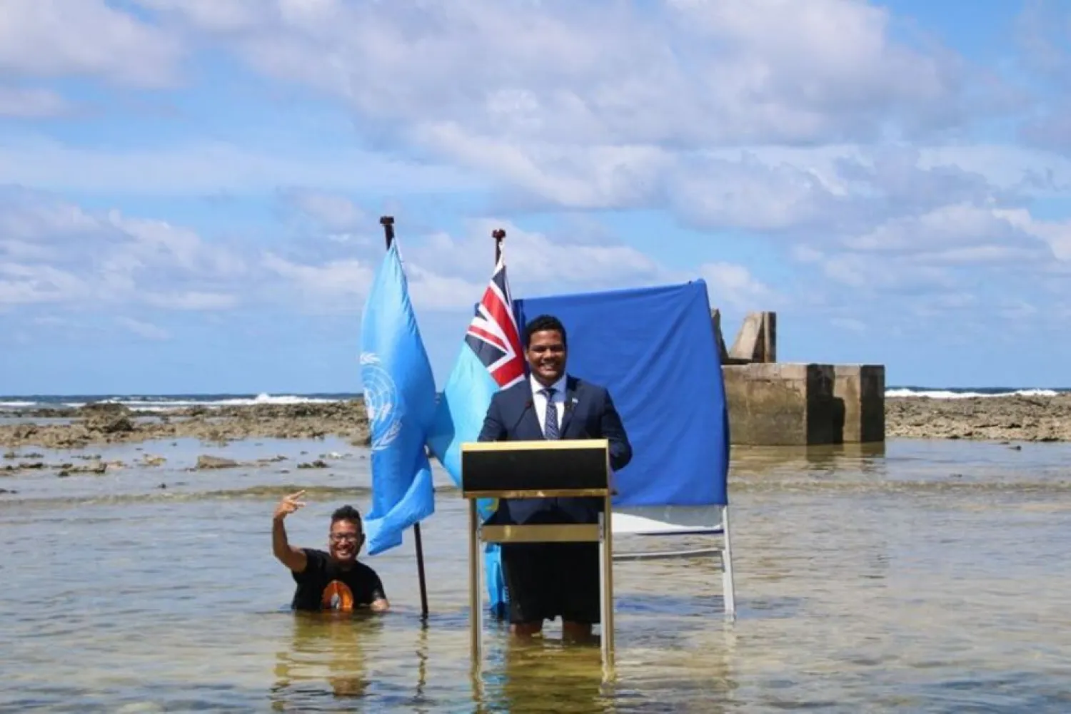 Tuvalu's Minister for Justice, Communication & Foreign Affairs Simon Kofe gives a COP26 statement while standing in the ocean in Funafuti, Tuvalu November 5, 2021. (Reuters)