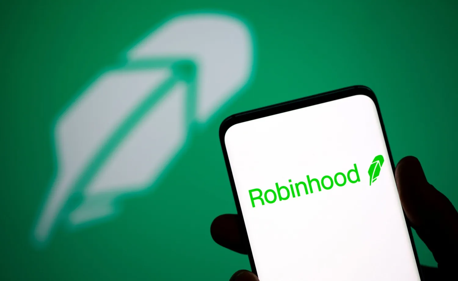 Robinhood logo is seen on a smartphone in front of a displayed same logo in this illustration taken, July 2, 2021. REUTERS/Dado Ruvic/Illustration

