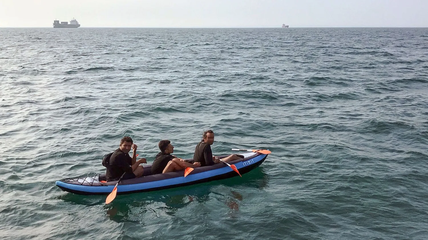 STR / AFP | Migrants attempting to cross the English Channel drift in an inflatable canoe off the French coast at Calais on August 4, 2018, before being rescued by lifeguards.
