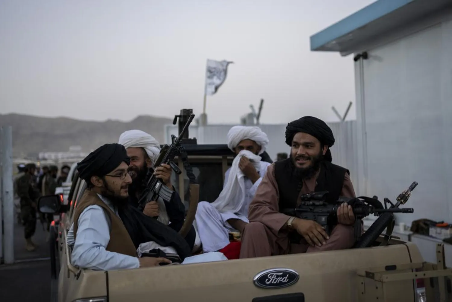 Taliban fighters sit in a pickup truck at the airport in Kabul, Afghanistan, Thursday, Sept. 9, 2021. (AP Photo/Bernat Armangue)
