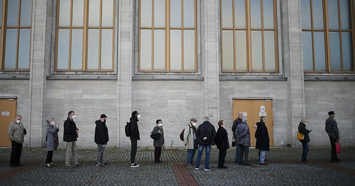 People line up for vaccination injections at the vaccination center of the Malteser relief service on the fair grounds in Berlin, Germany, Wednesday, Nov. 3, 2021   -   Copyright  AP Photo/Markus Schreiber

