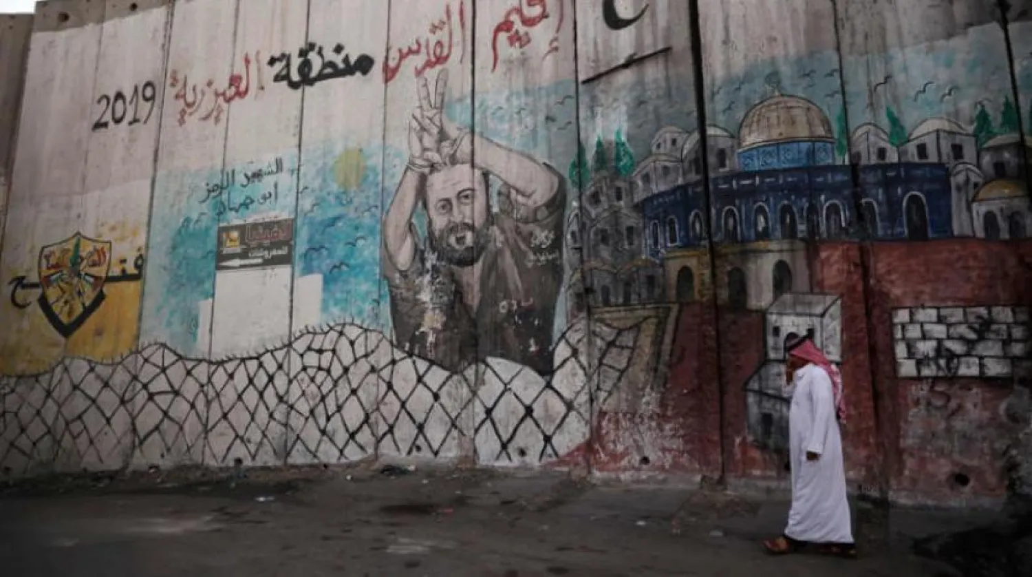 A Palestinian man walks near the separation barrier in Jerusalem in the West Bank. (AFP)
