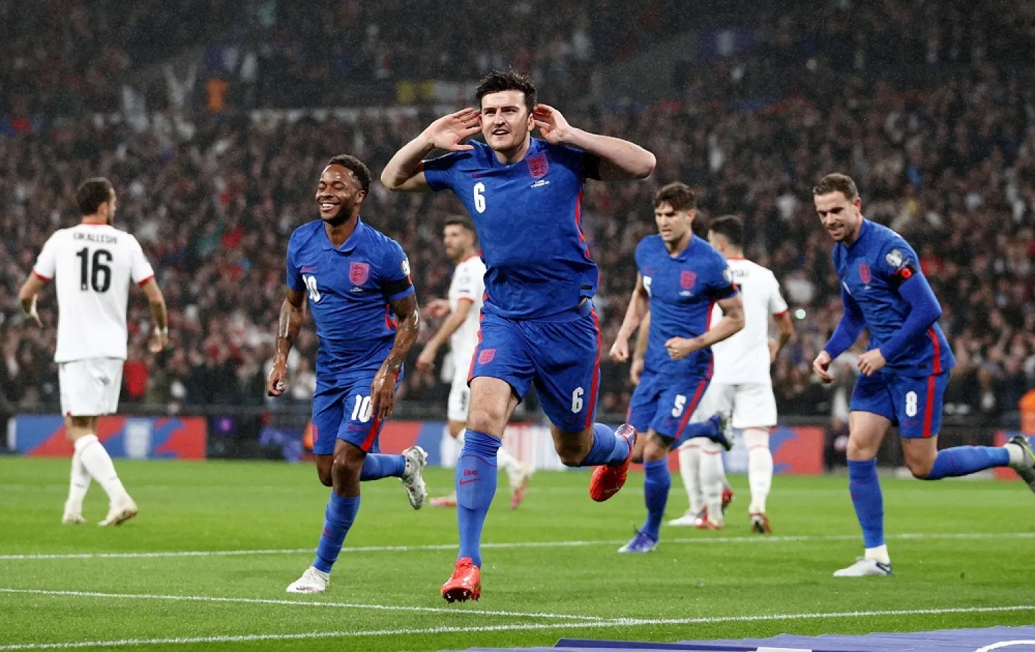 England's Harry Maguire celebrates after scoring the first goal against Albania November 13, 2021. (Reuters)