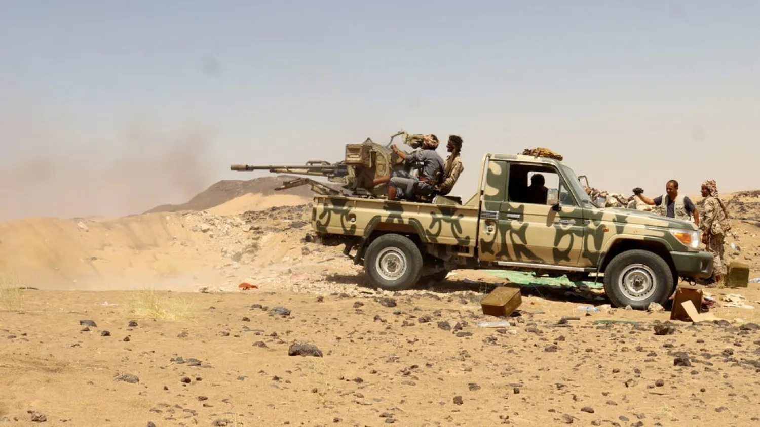 A Yemeni government fighter fires a vehicle-mounted weapon at a frontline position during fighting against Houthi fighters in Marib (Reuters) 

