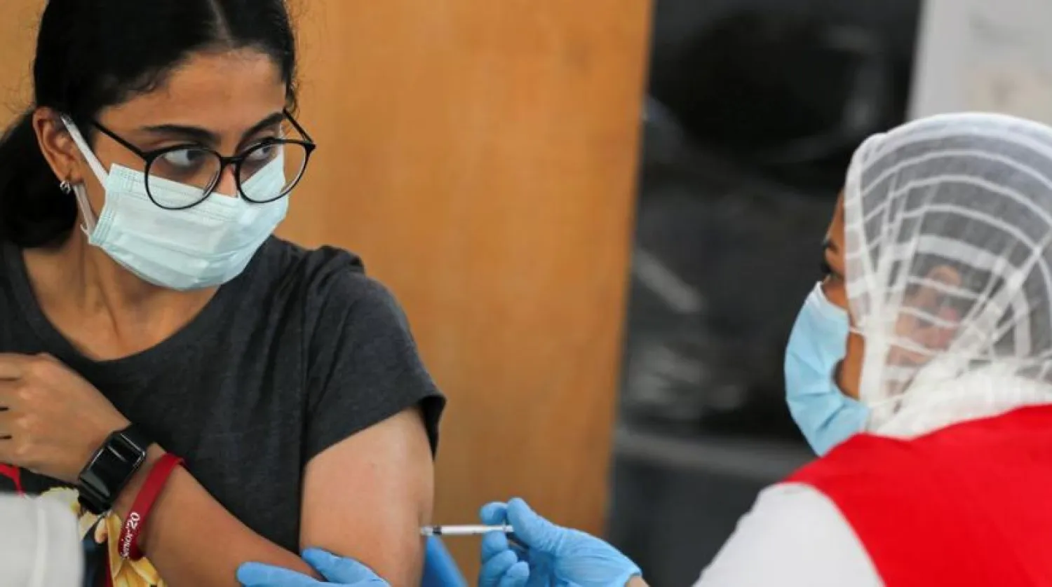 A woman receives a dose of the coronavirus disease (COVID-19) vaccine at one of the Youth centers where citizens can get the vaccines without prior registration, in an effort to boost the country's vaccination drive, in Cairo, Egypt, September 27, 2021. REUTERS/Mohamed Abd El Ghany
