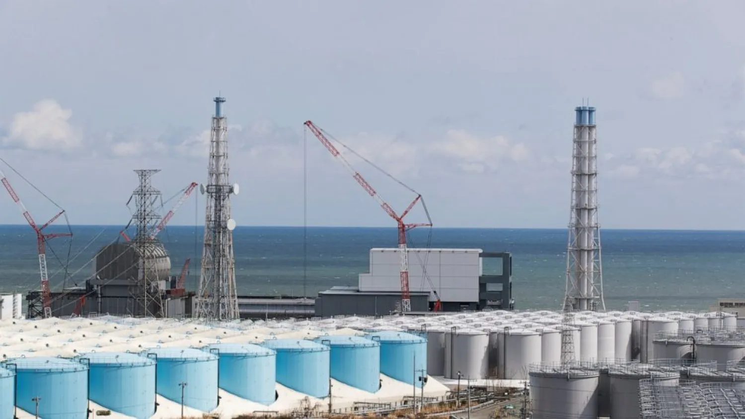 FILE - The Pacific Ocean looks over nuclear reactor units of No. 3, left, and 4 at the Fukushima Daiichi nuclear power plant in Okuma town, Fukushima prefecture, northeastern Japan on Feb. 27, 2021. A team from the UN nuclear agency arrived in Japan on Monday, Nov. 15, 2021 to assess preparations for the release into the ocean of treated radioactive water from the wrecked Fukushima nuclear plant. (AP Photo/Hiro Komae, File)
