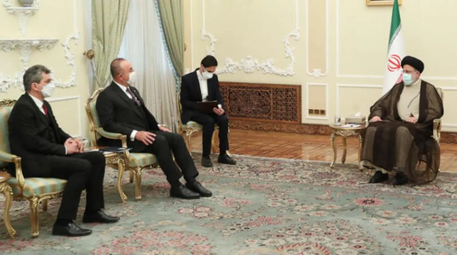 Iranian President Ibrahim Raisi received Turkish Foreign Minister Mevlut Cavusoglu (EPA)