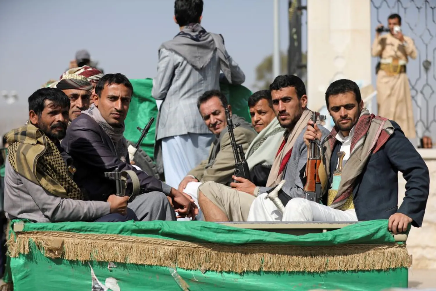 Armed Houthi followers ride on the back of a truck after participating in a funeral of Houthi fighters killed in recent fighting against government forces in Yemen's oil-rich province of Marib, in Sanaa, Yemen February 20, 2021. REUTERS/Khaled Abdullah
 
