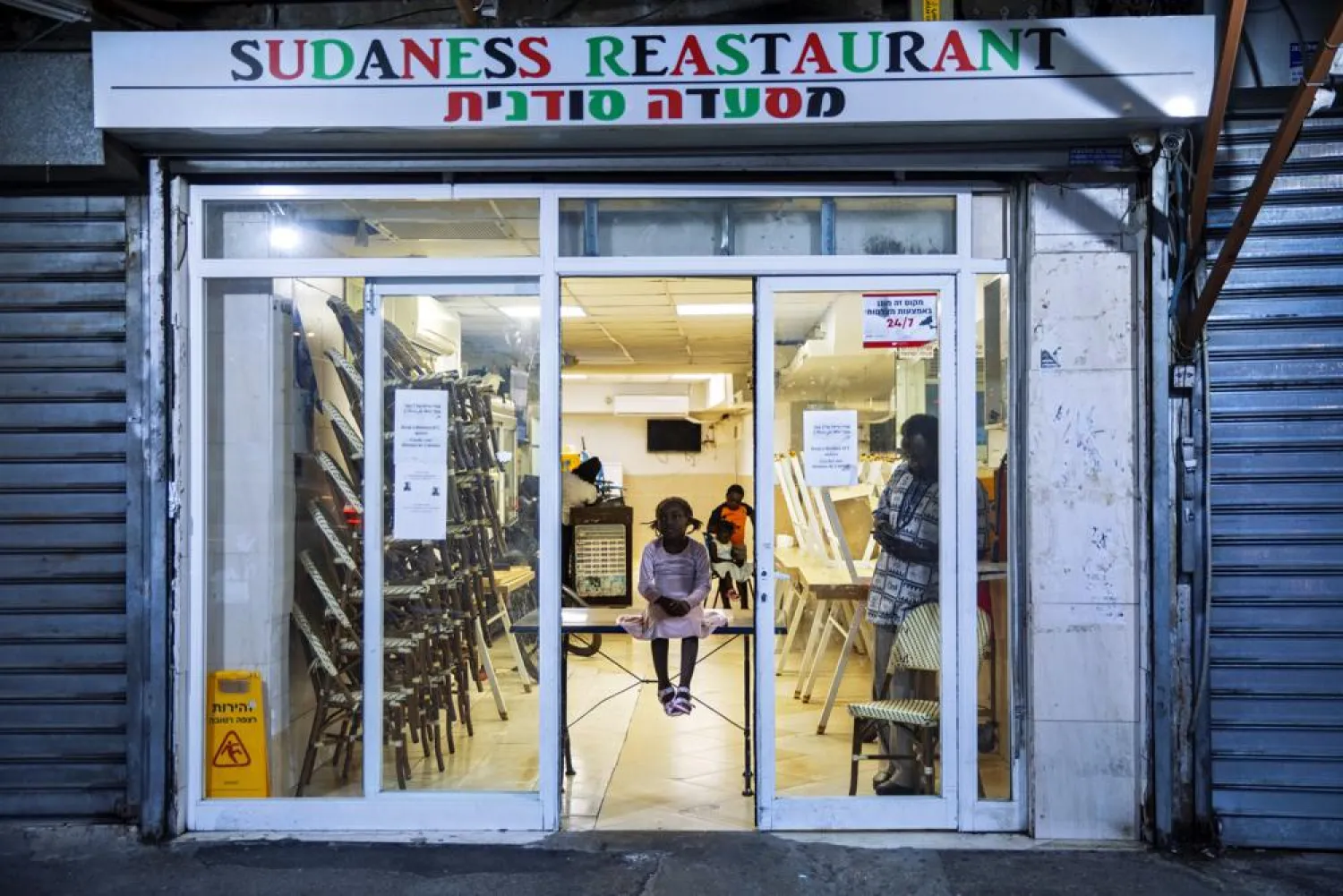 FILE - A Sudanese migrant family are seen in a closed Sudanese restaurant in south Tel Aviv, Israel, Oct. 27, 2020. (AP Photo/Oded Balilty, File)
