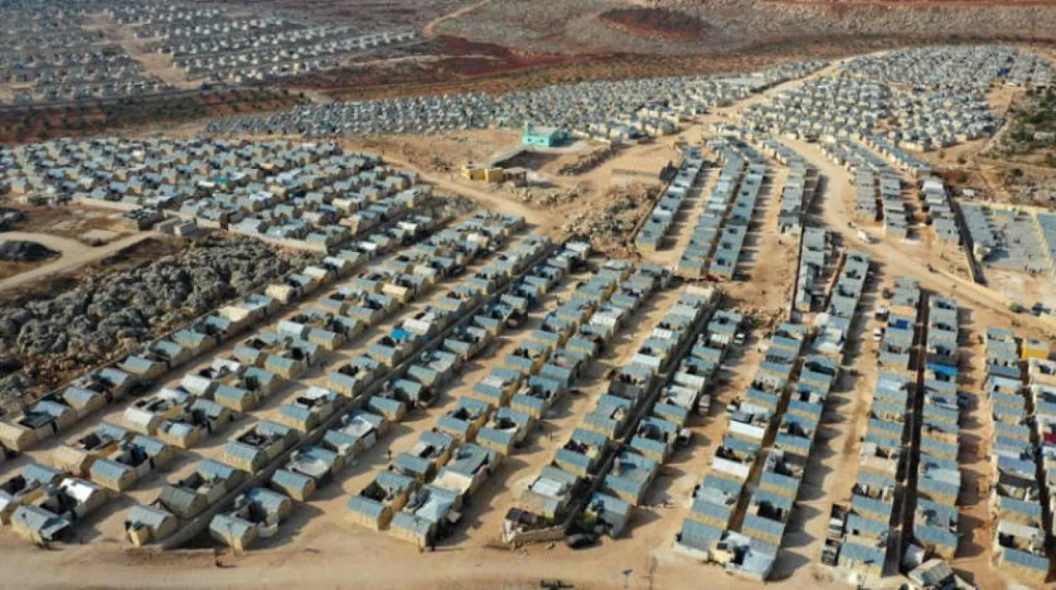 An aerial view shows shelters at the newly-established Watan camp for internally displaced people in the village of Kafr Jales in Syria's northwestern Idlib province, on November 17, 2021. (Photo by Omar HAJ KADOUR / AFP)