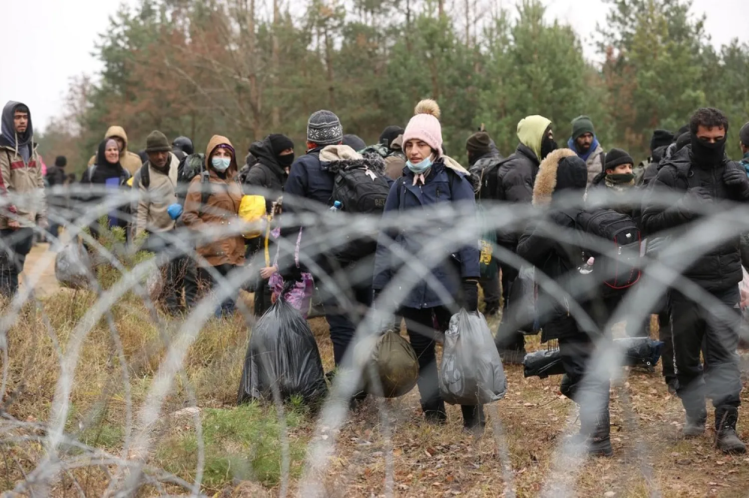 Migrants gather on the Belarusian-Polish border in an attempt to cross it at the Bruzgi-Kuznica Bialostocka border crossing, Belarus November 15, 2021. (Reuters)