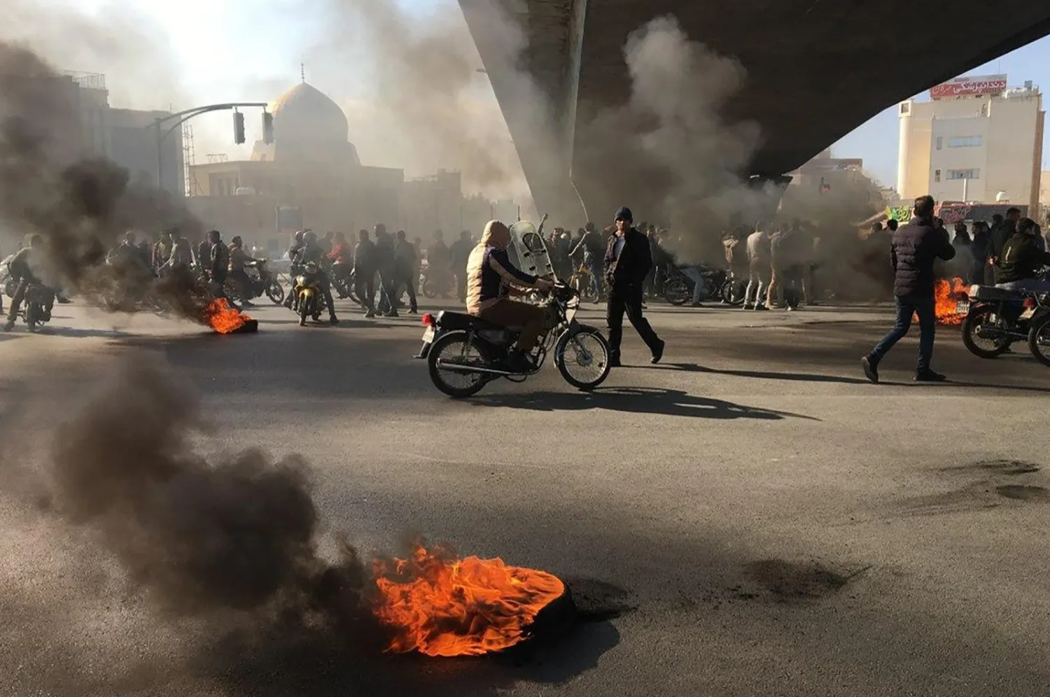 Iranian protesters rally amid burning tires during a demonstration against an increase in gasoline prices, in the central city of Isfahan, Iran, Nov. 16, 2019. (AFP Photo)
