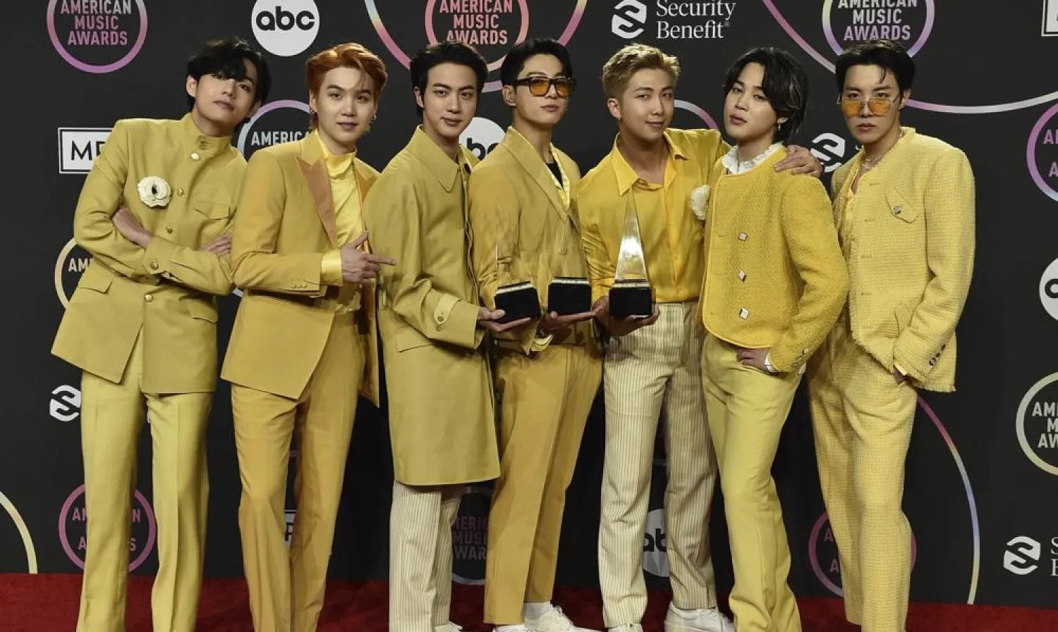 BTS poses in the press room with the awards for favorite pop duo or group, favorite pop song for “Butter,” and artist of the year at the American Music Awards on Sunday, Nov. 21, 2021, at Microsoft Theater in Los Angeles. (AP)