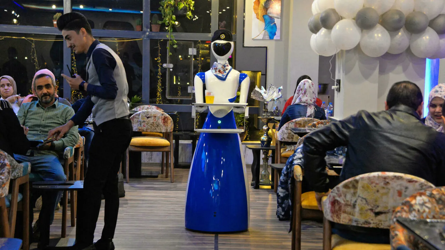 A robot waiter carries a bill to patrons of the White Fox restaurant in the northern Iraqi city of Mosul. Zaid AL-OBEIDI AFP
