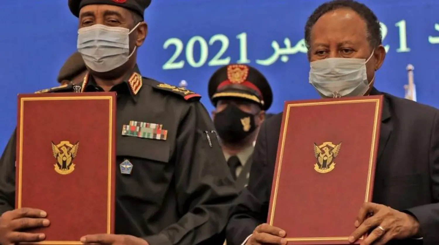 Sudan's top general Abdel Fattah al-Burhan, on the left, and Prime Minister Abdalla Hamdok during the deal-signing ceremony to restore the transition to civilian rule. (AFP)