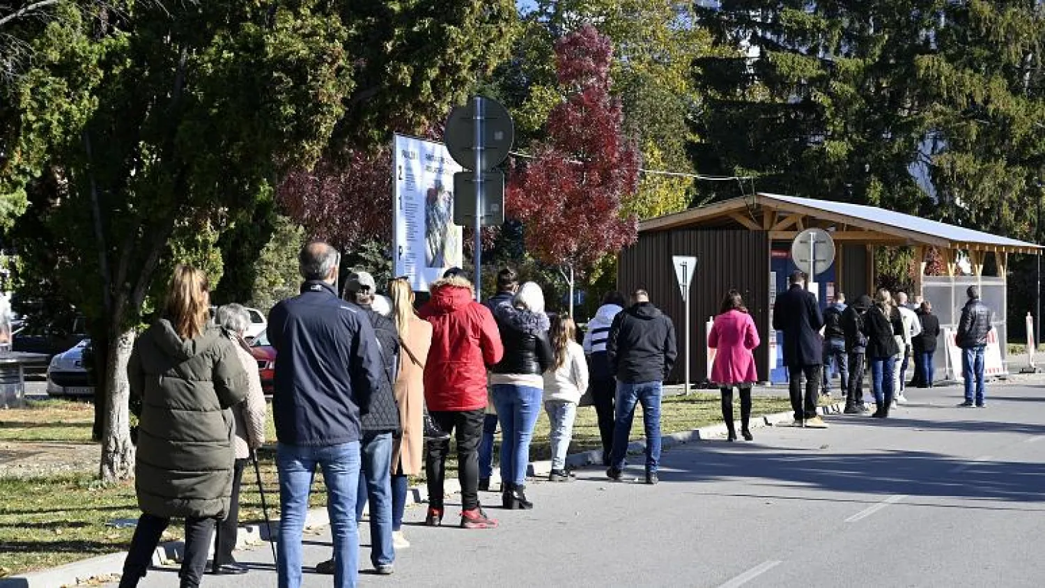 People stand in line to test for COVID-19 in Michalovce, Slovakia, Monday, Oct. 25, 2021. Roman Hanc/TASR via AP