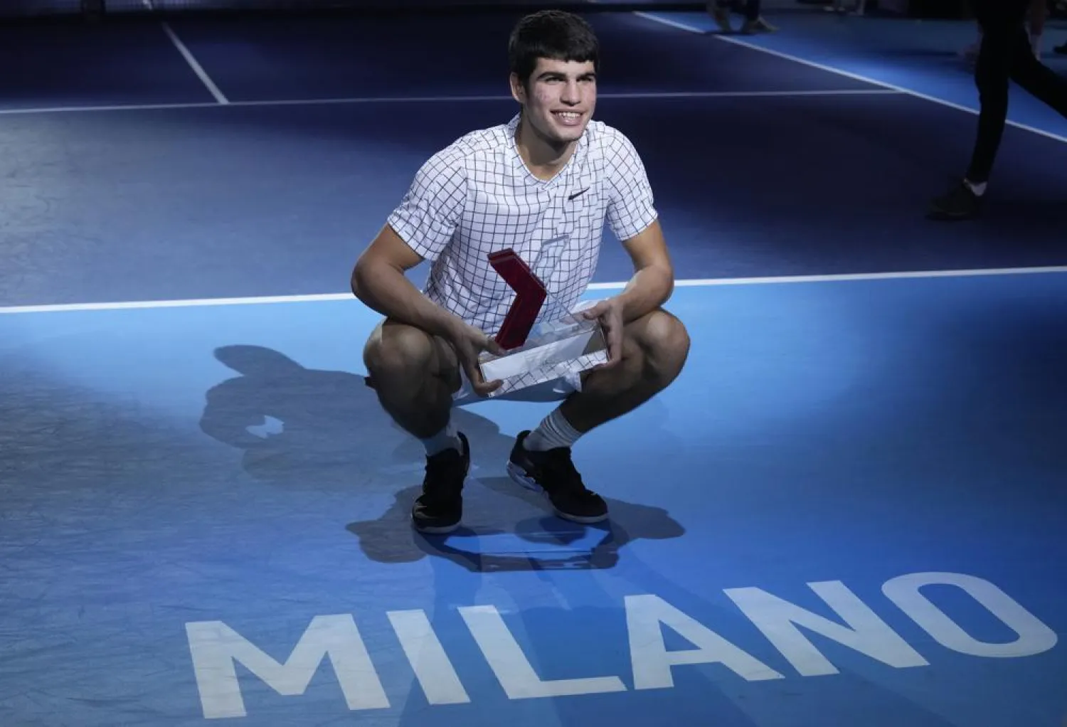 Spain's Carlos Alcaraz celebrates with a trophy after winning the ATP Next Gen final tennis tournament against United States' Sebastian Korda, in Milan, Italy, Saturday, Nov. 13, 2021. (AP)