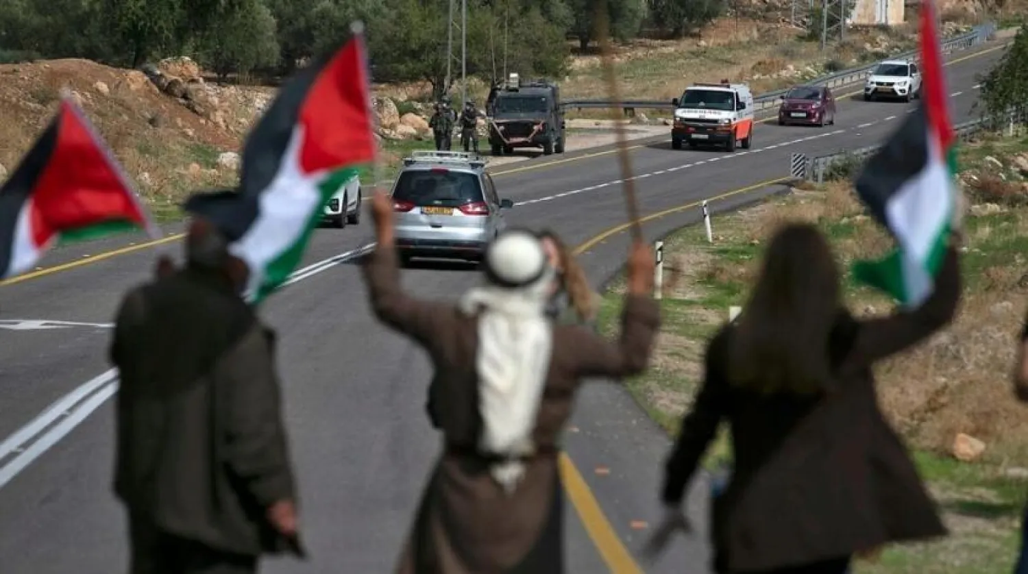 Palestinians block a road to stop Israeli settlers from passing during a demonstration against Jewish settlements in the village Kafr Malik in the Israeli-occupied West Bank, on November 20, 2020. (Getty Images)
