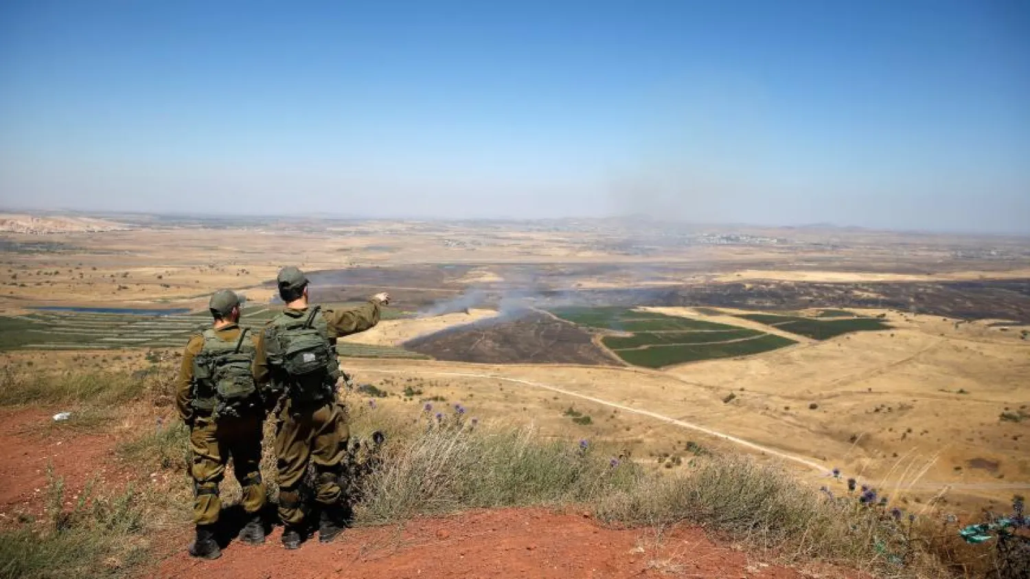 Israeli soldiers look at Syria from the Israeli-occupied Golan Heights border, July 7, 2018. (Reuters)