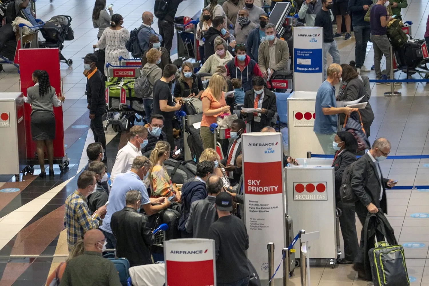 People line up to get on the Air France flight to Paris at OR Tambo International Airport in Johannesburg, South Africa, Friday Nov. 26, 2021 (AP)