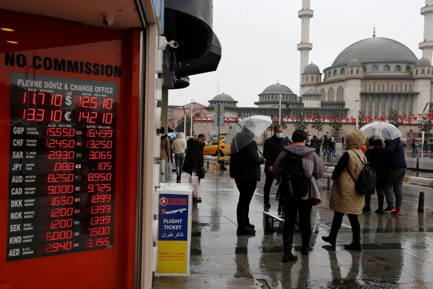 People stand outside a currency exchange office in Istanbul, Turkey November 23, 2021. (Reuters)