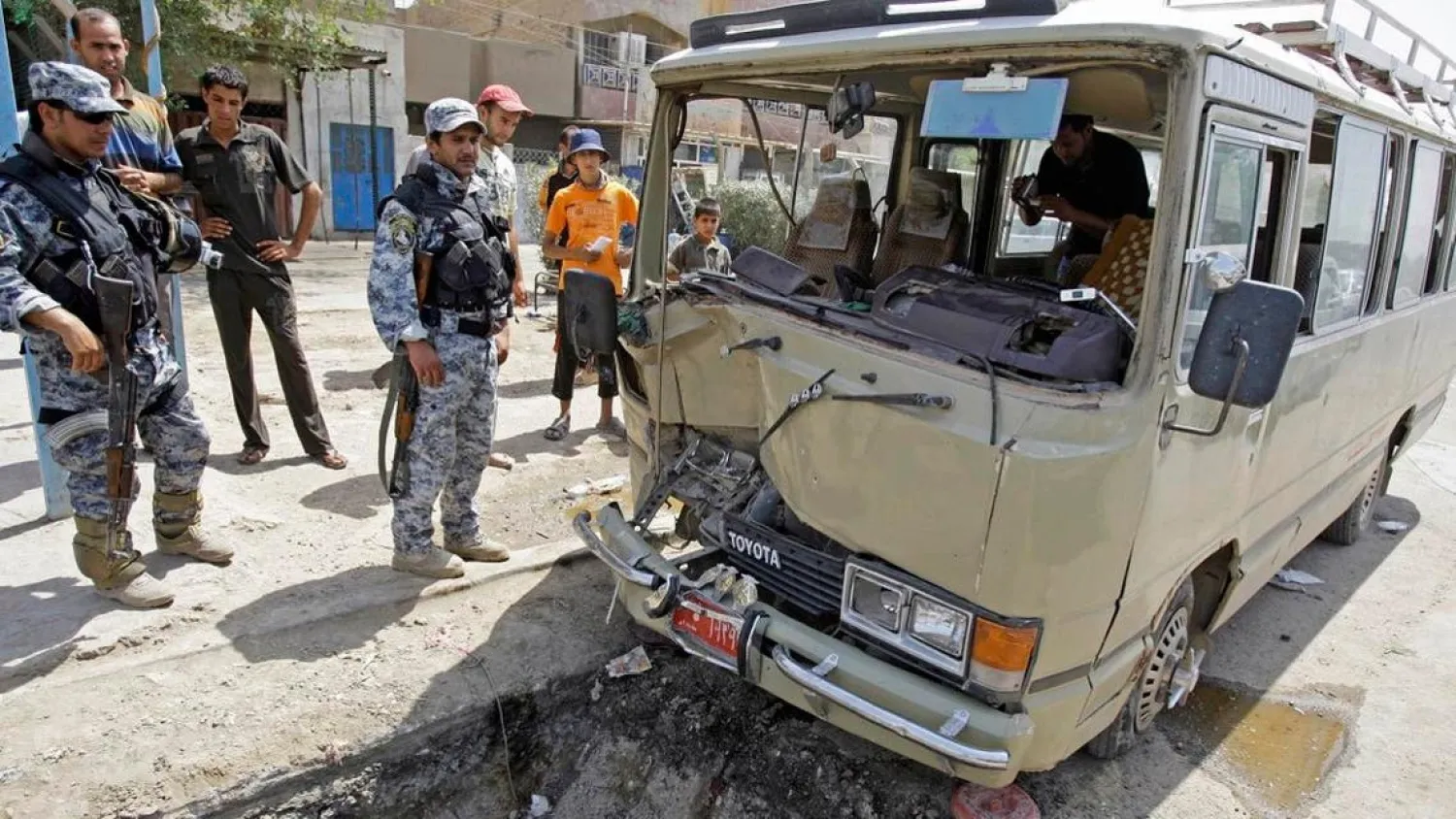 File photo of Iraqi policemen secure the scene of a road side bomb blast that hit a mini bus in Baghdad, Iraq. (FILE/AP)
