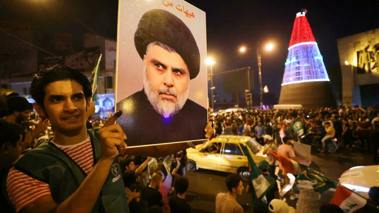 Supporters of cleric Moqtada al-Sadr celebrate in Baghdad's Tahrir square on October 11, 2021 following the announcement of parliamentary elections' initial results. (AFP)