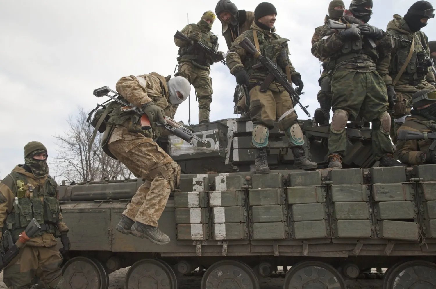 A Russia-backed rebel jumps off a tank in Debaltseve, Ukraine, Feb. 20, 2015. (AP Photo)