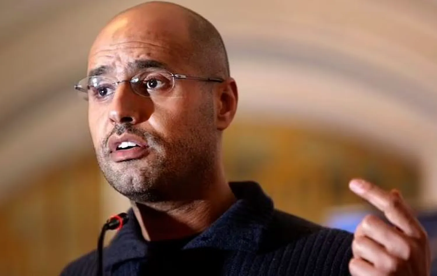 FILE - In this Feb. 25, 2011, file photo, Seif al-Islam Gadhafi speaks to the media at a press conference in a hotel in Tripoli, Libya. (AP Photo/Ben Curtis, File)

