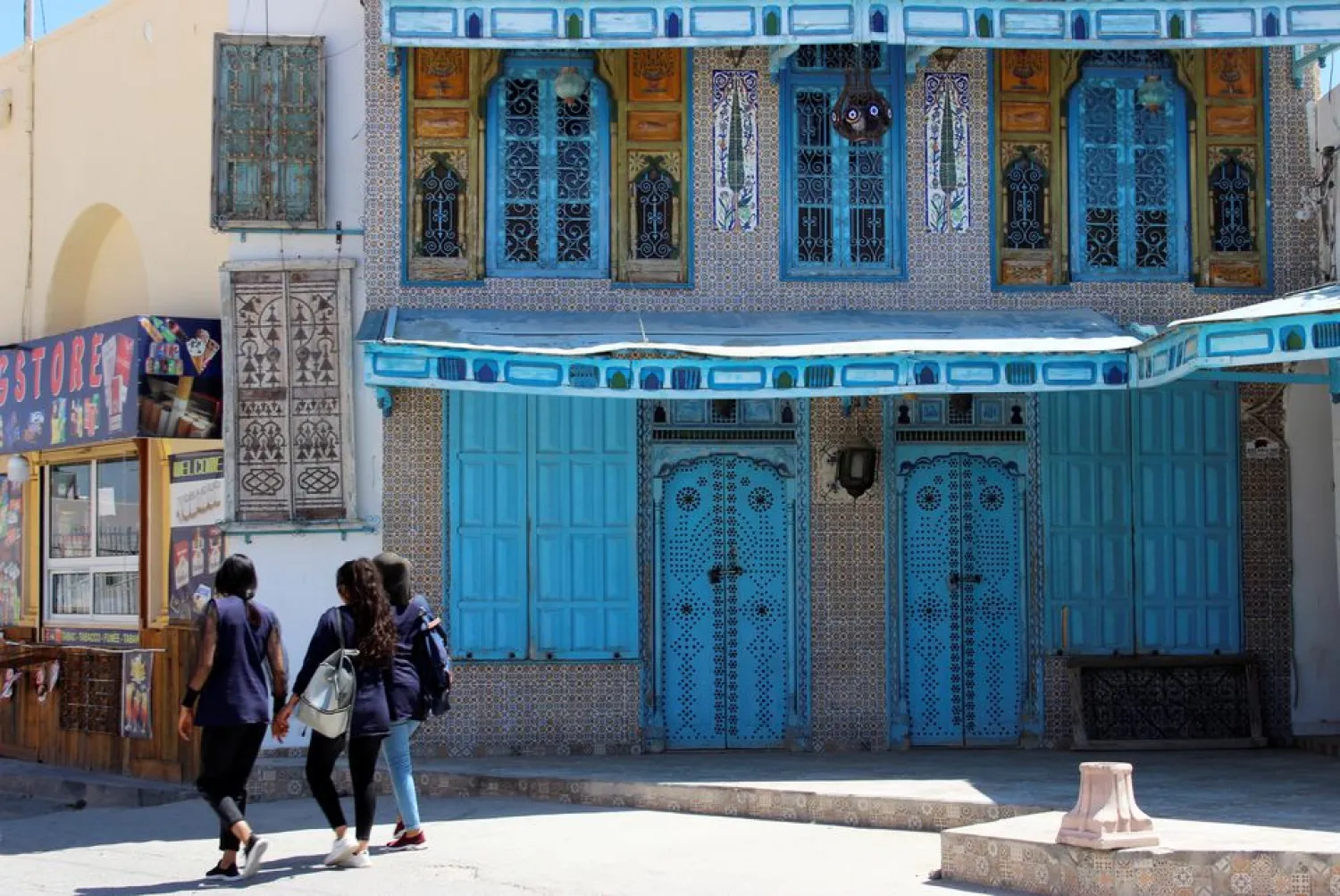 Girls walk past a closed souvenir shop in El Jem, amid the coronavirus disease (COVID-19) outbreak, Tunisia, May 20, 2021. (Reuters)