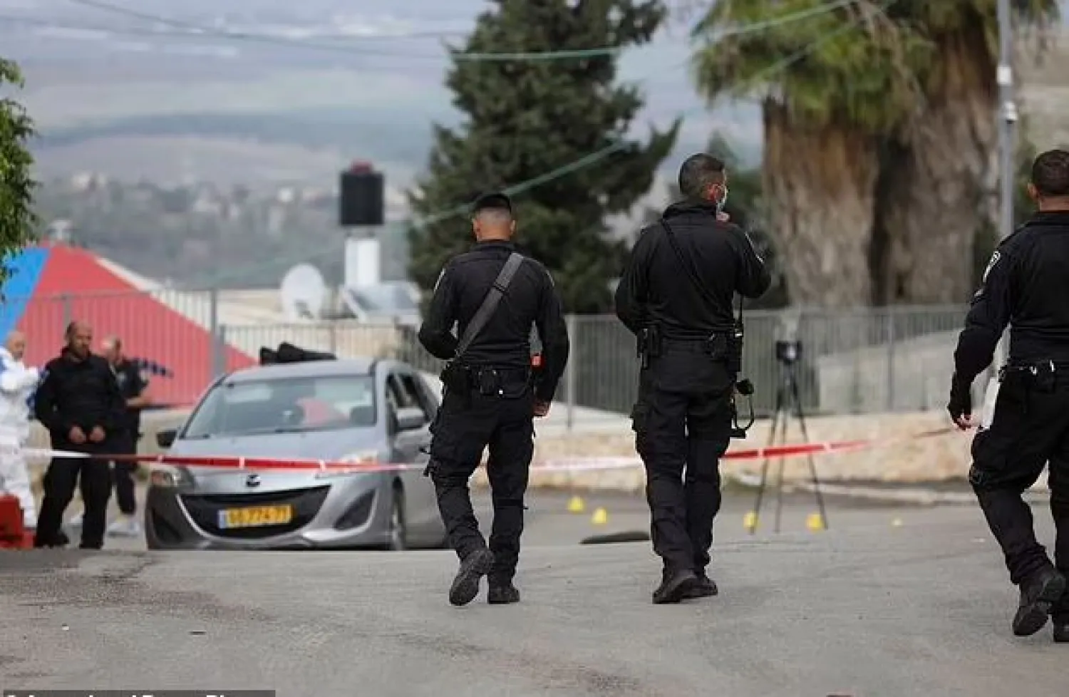 Police work at the scene in Umm el-Fahm, Israel, Friday, Dec. 3, 2021, after a man was shot dead by Israeli police in a car-ramming incident following a night of intense violence in the Arab populated Israeli town. (AP Photo/Mahmoud Illean)

