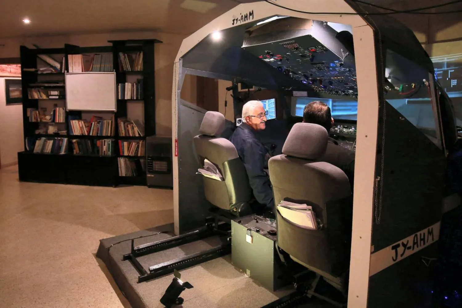 Muhammad Malhas sits at his flight simulator cockpit at his home in Jordan's capital Amman. AFP