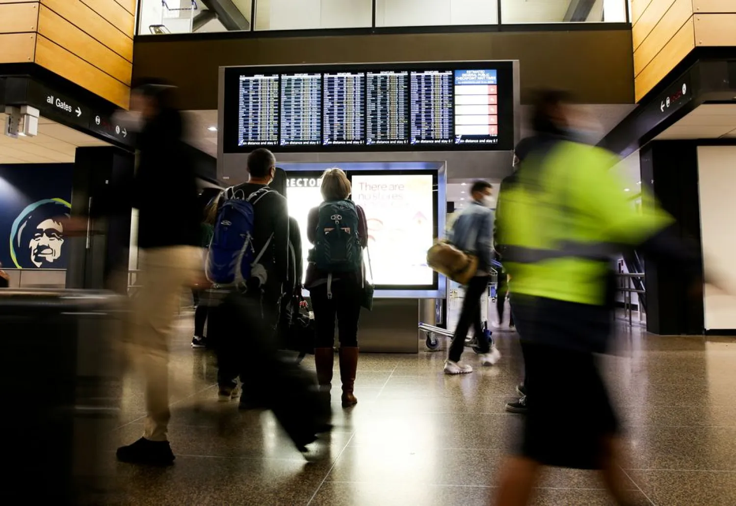 Travelers check a departures list at the ticketing level of Seattle-Tacoma International Airport before the Thanksgiving holiday in Seattle, Washington, US November 24, 2021. (Reuters)